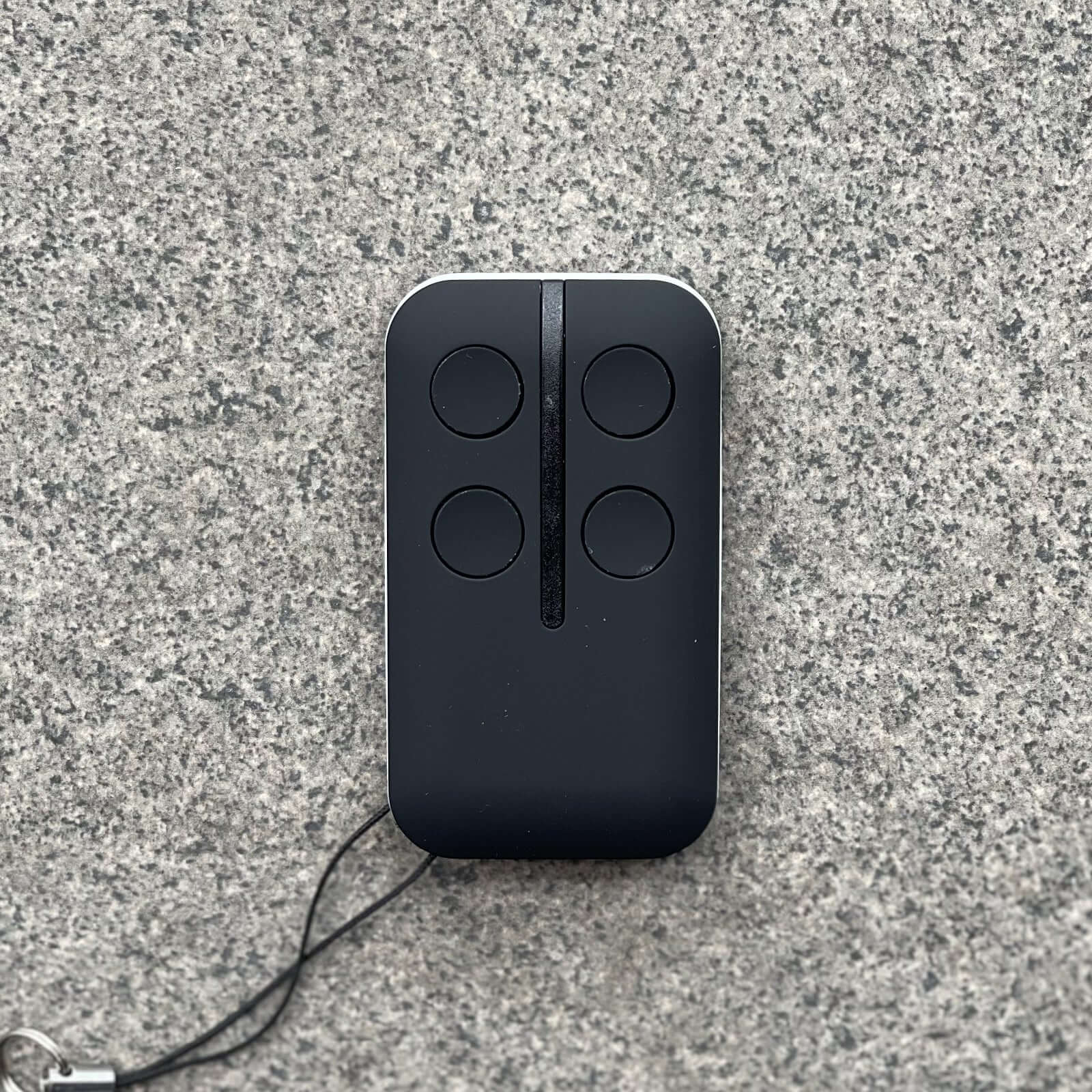 HomEntry HE60/HE60R replacement garage remote with four buttons on gray background, includes battery and key ring.