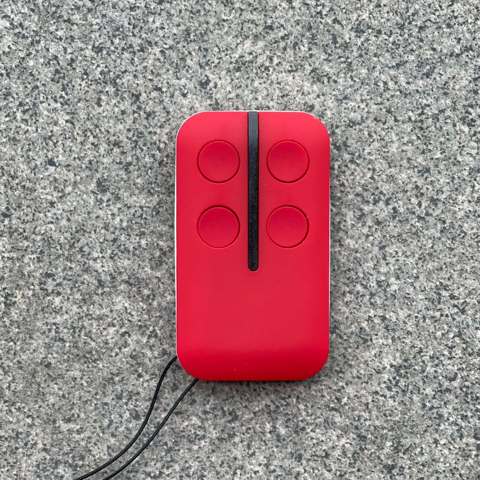 Red HomEntry HE60/HE60R replacement garage remote on gray surface, compatible with Garageway models HE60, HE60R, HE60ANZ, HE4331.