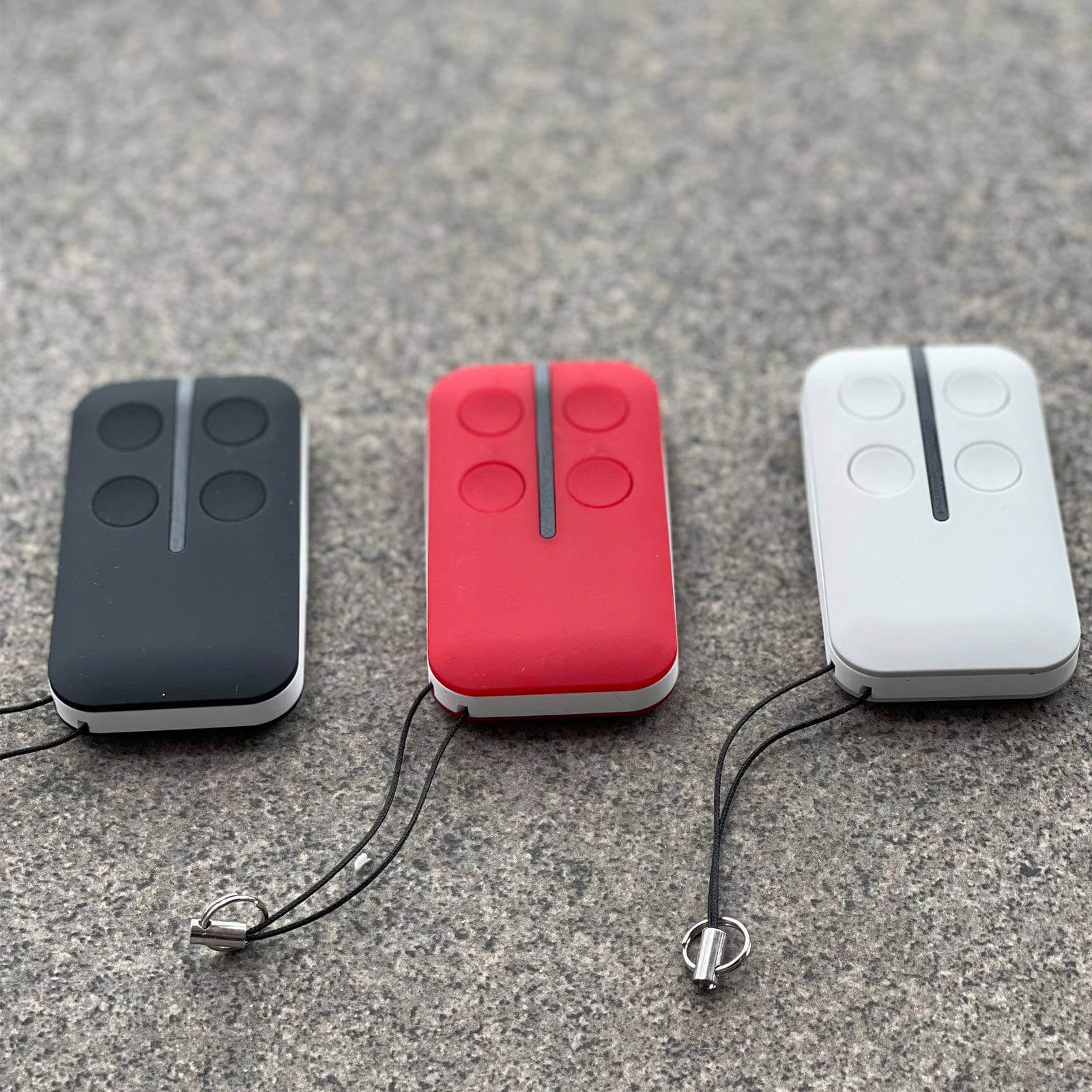 Black, red, and white ATA PTX4 replacement remote controls displayed on a stone surface, compatible with various Garageway models.