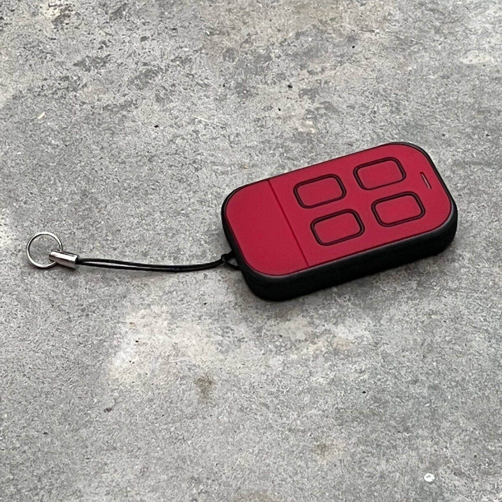ATA PTX5 v1 TrioCode replacement remote with four buttons, displayed on a concrete surface.