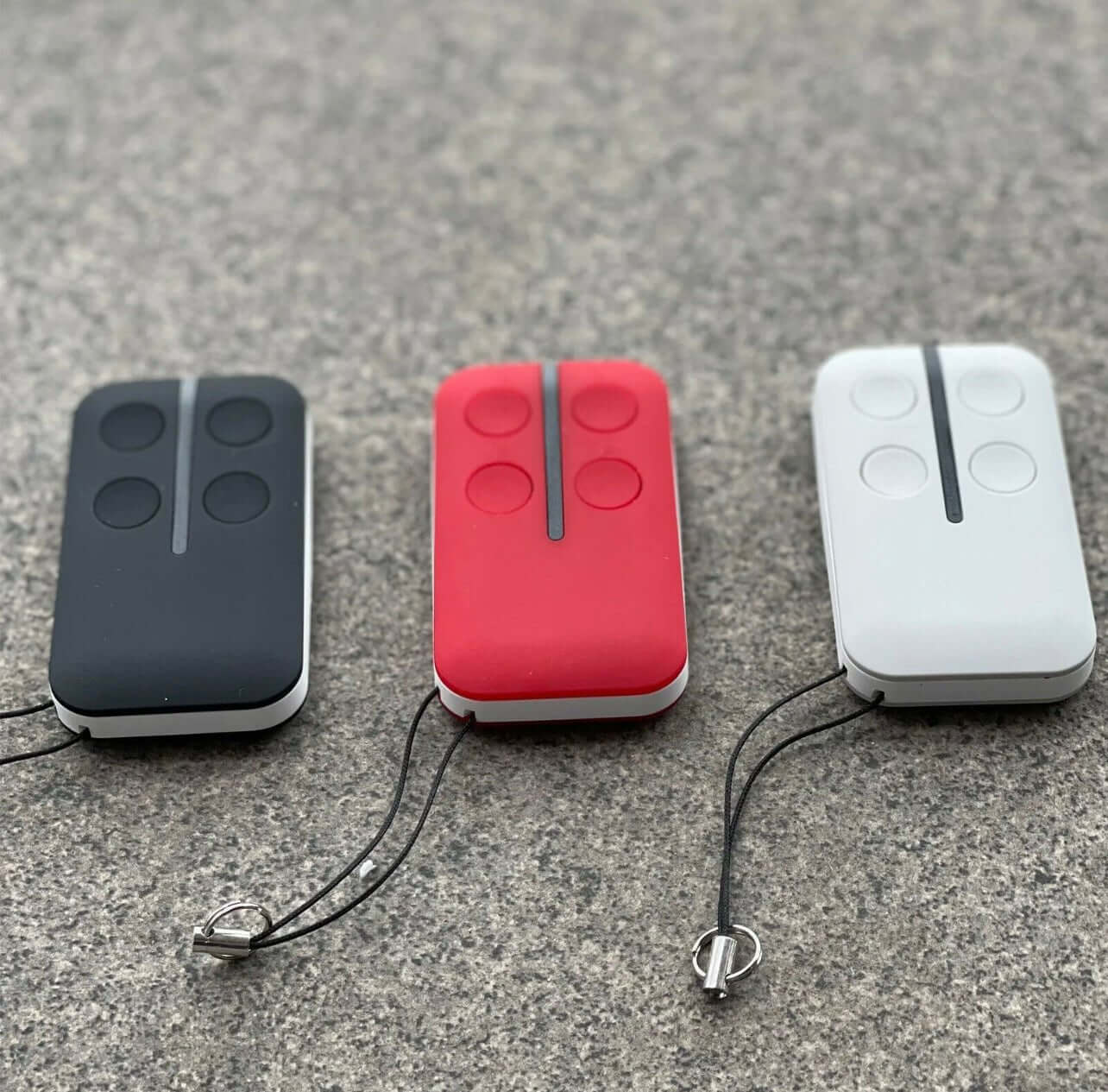 Three Gliderol TM-305C GTS2000 replacement remotes in black, red, and white with key rings, compatible with Garageway systems.