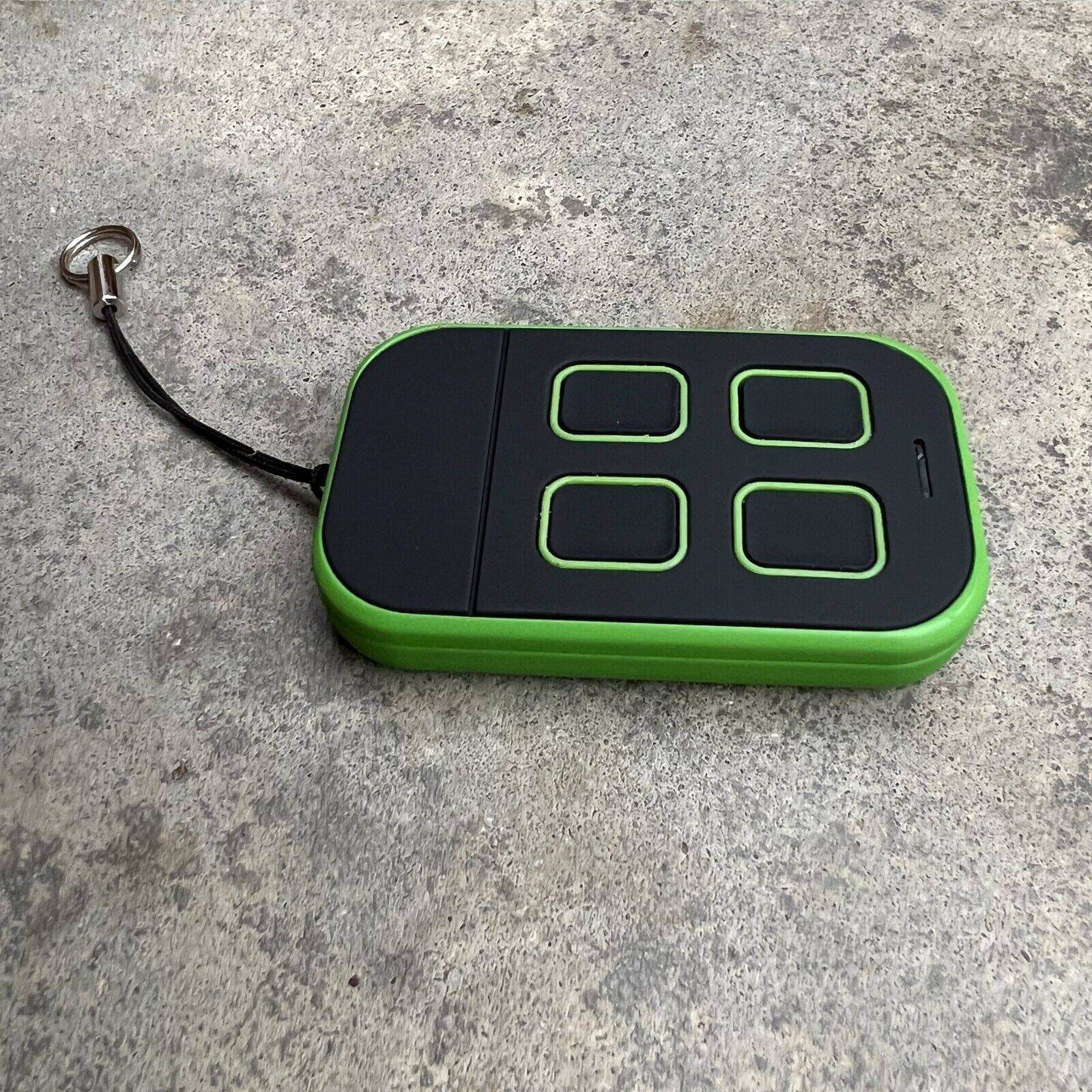 Merlin+ C945 compatible remote control with green and black design on a textured surface.