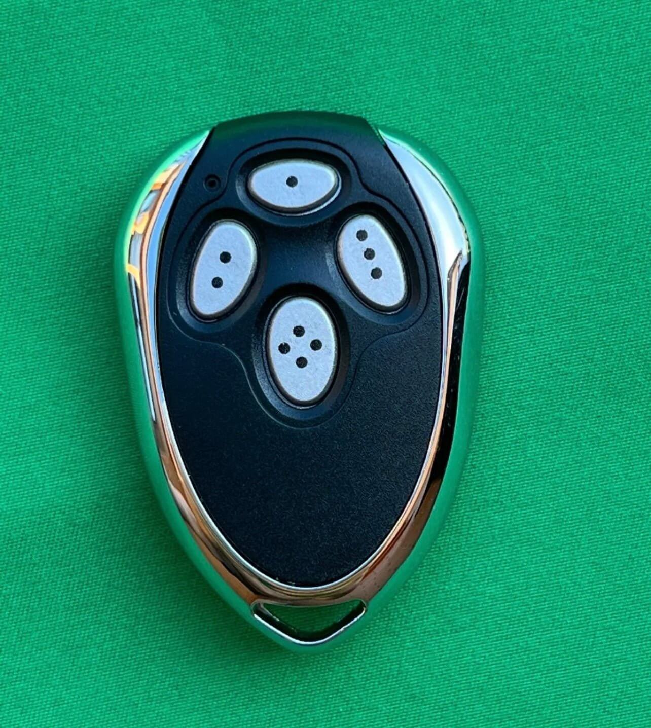 Smart Openers Compatible Remote with chrome details on a green background, ideal for Garageway gates and garage systems.